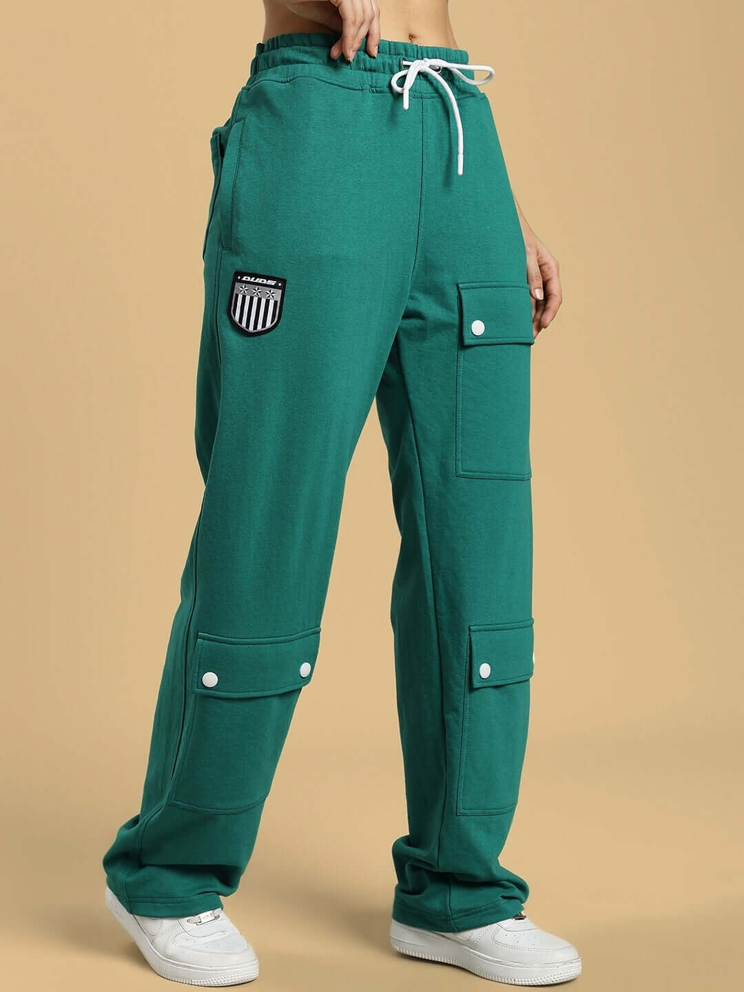 Women's green baggy jogger with flap pockets, featuring a customizable fit and made by DUDS for comfort and style.