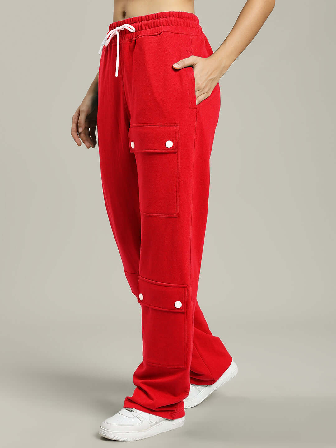 Red women's joggers with flap pockets, made to order by DUDS, shown with elastic waistband and white drawstring.