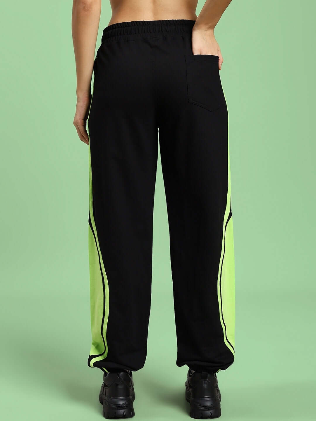 Back view of Women's Aziza Co-Ord Set joggers in black and neon-green with elasticated waistband and drawstring, showcasing unisex relaxed fit.