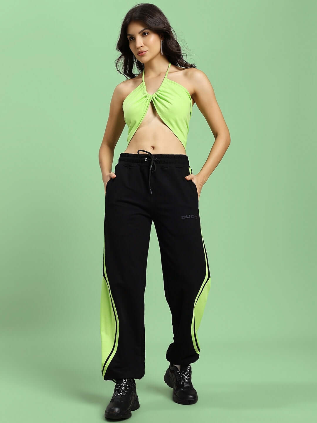 Black neon-green women's Aziza co-ord set with relaxed fit joggers and halter top on model. Perfect for stylish, casual wear.