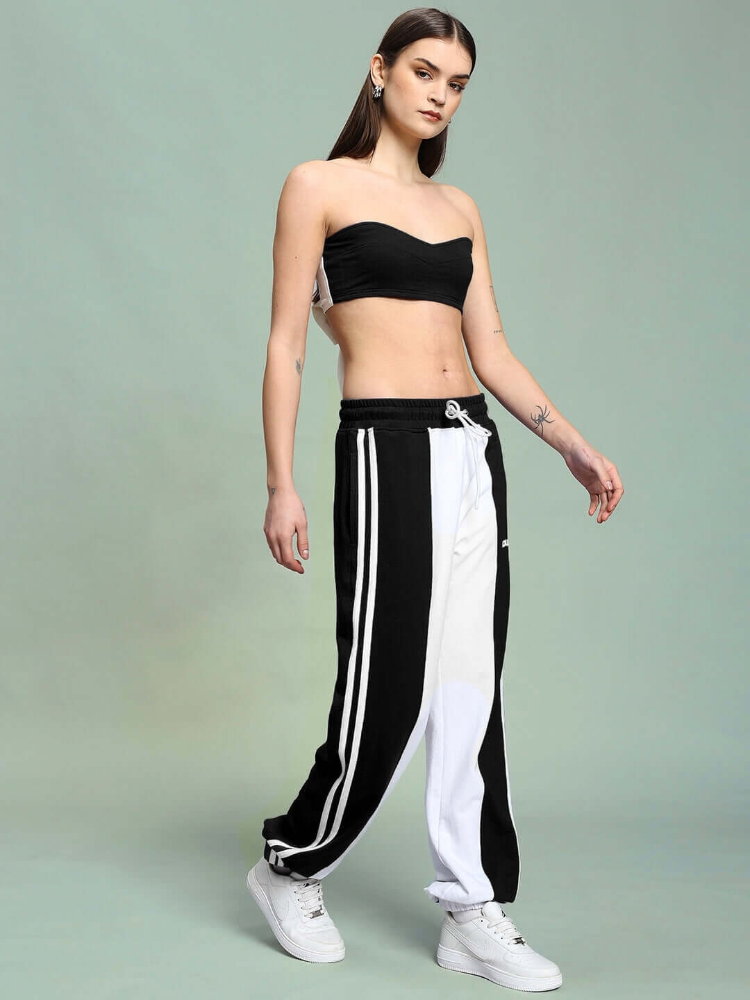 Model wearing Women's Azora Co-Ord Set in black-white with relaxed fit joggers, elasticated waistband, and stylish side stripe design.