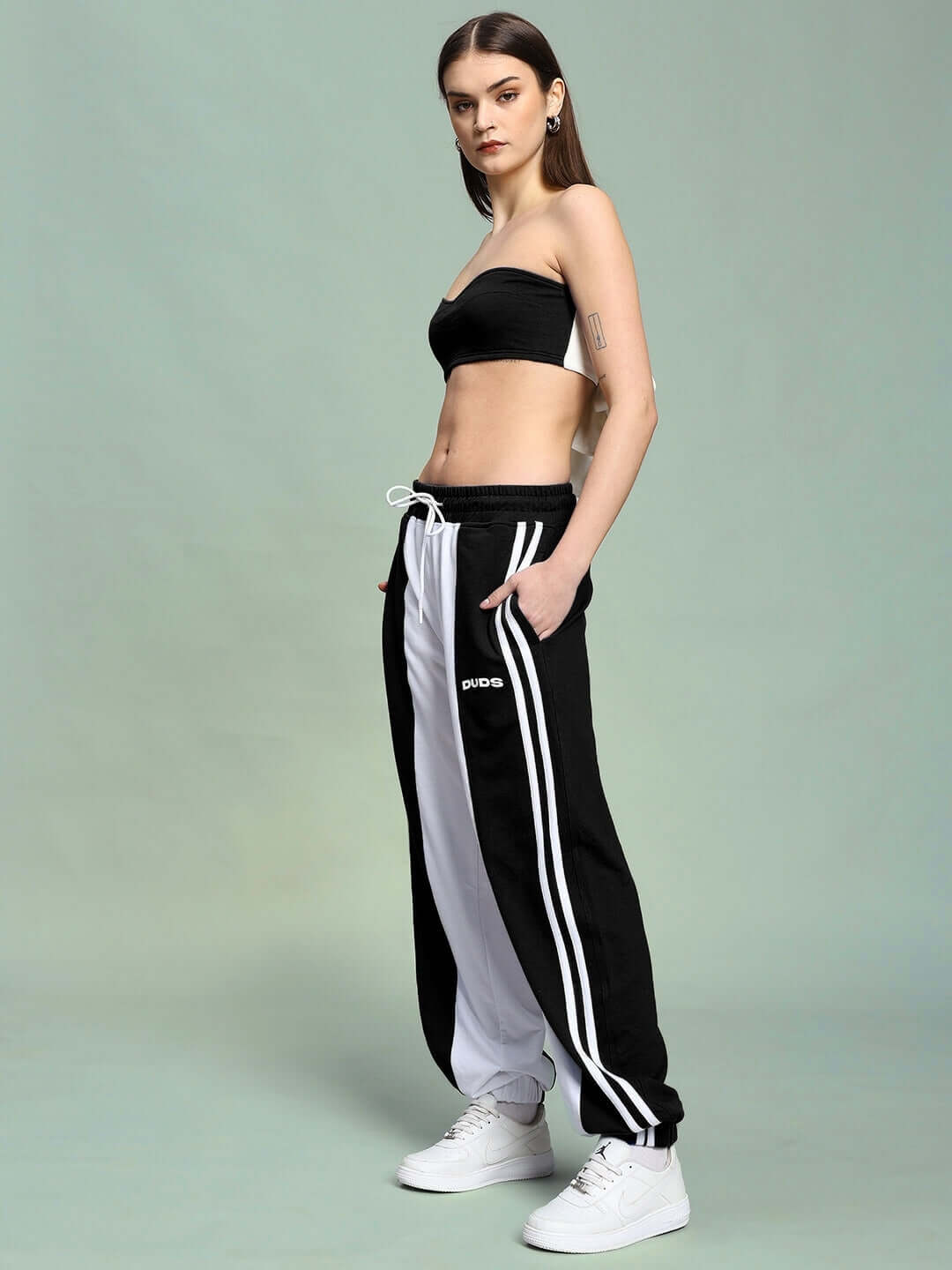 Woman wearing the Women's Azora Co-ord Set in black and white, featuring relaxed fit joggers with elasticated waistband and drawstring.