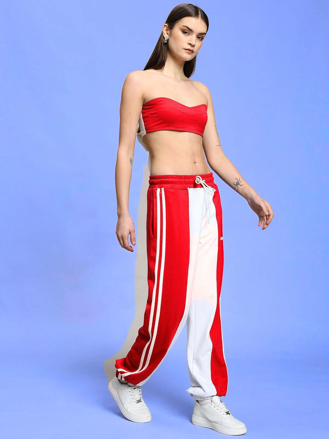 Model wearing Women's Azora Co-ord Set in red and white with relaxed fit joggers, elastic waist, and drawstring for customizable fit.