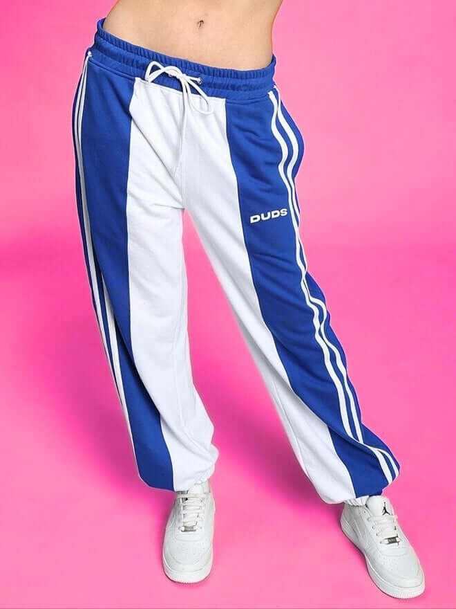 Women's balmy relaxed fit jogger in white and blue by DUDS on a pink background.