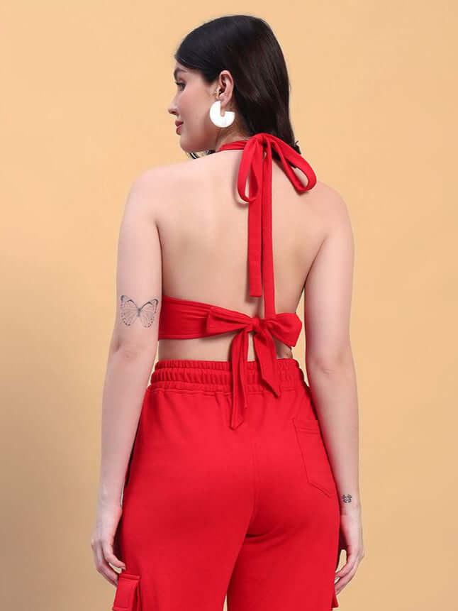 Back view of a woman wearing a red crop-top and pants set, showcasing tied bow details, made from premium cotton French Terry Lycra.
