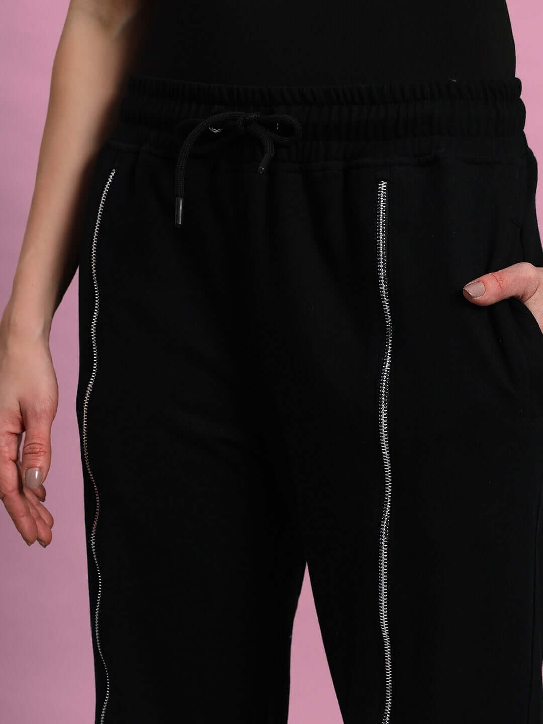 Women's Brazo front open zipper joggers in black with elastic waistband and drawstring detail.