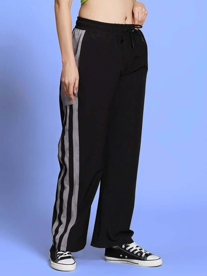 Model wearing black relaxed fit cargo pant with elasticated waistband and side pockets, showcasing casual unisex style.