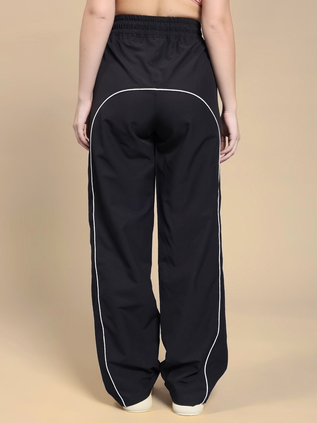 Rear view of WOMEN TURBO TRACK RELAXED-FIT JOGGERS BLACK highlighting sporty design.