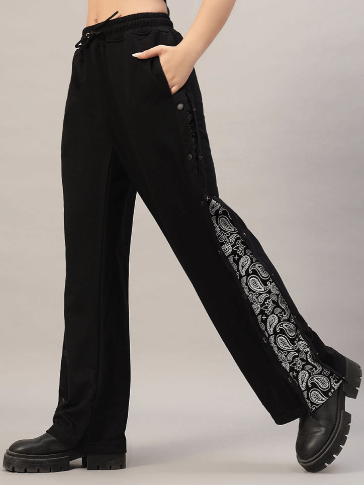 Woman wearing black Women's Mambo Joggers with paisley pattern, custom fit available, handcrafted by DUDS experienced tailors.