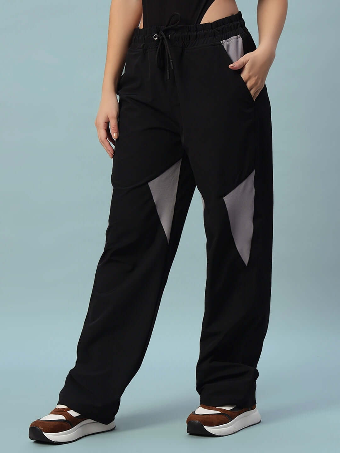 Women's black relaxed fit cargo pants with pockets, showcasing comfortable and stylish design for custom and regular fit options.