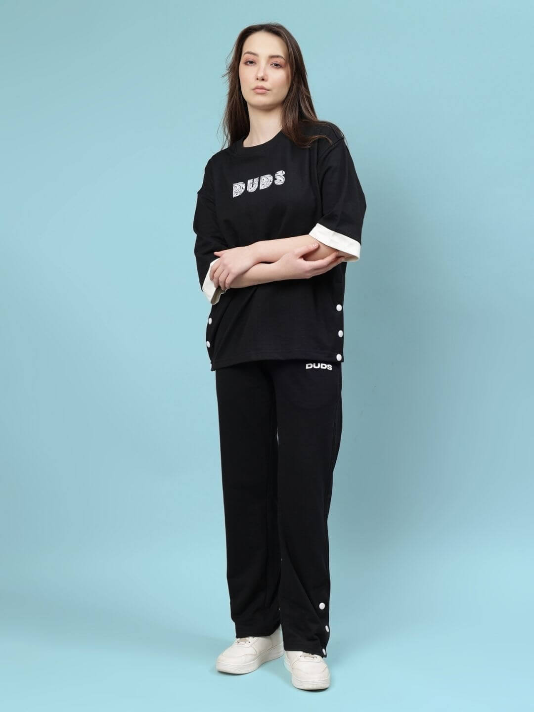 Woman wearing women's relaxed-fit co-ord set in black, featuring premium cotton and elastane blend. Comfortable and stylish casual wear.