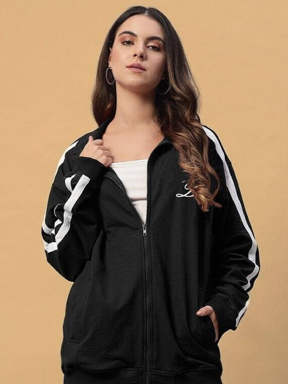 Model wearing women's Scotia jacket in black by DUDS, featuring a zip-front design and customizable fit options.