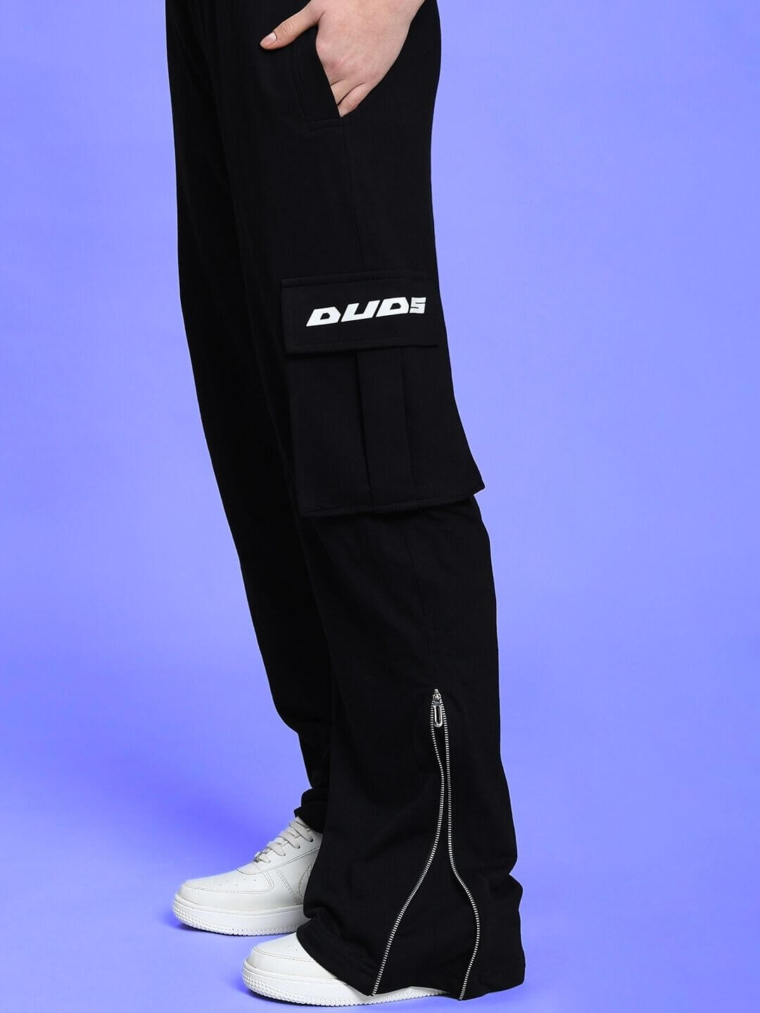 Model wearing Women's Skidder Cargo Pant in black by DUDS, featuring a cargo pocket and zip detail, made to order with custom size option.