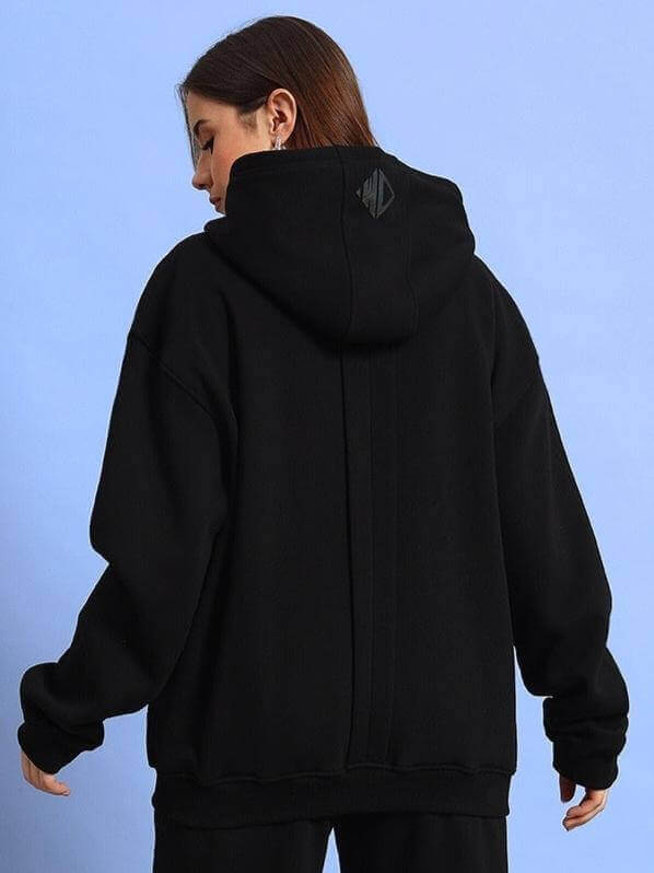Alt Tag: Woman wearing black WD Admire Co-Ord, featuring a hoodie and loose fit, crafted with care by DUDS tailors. Ideal for custom fit.