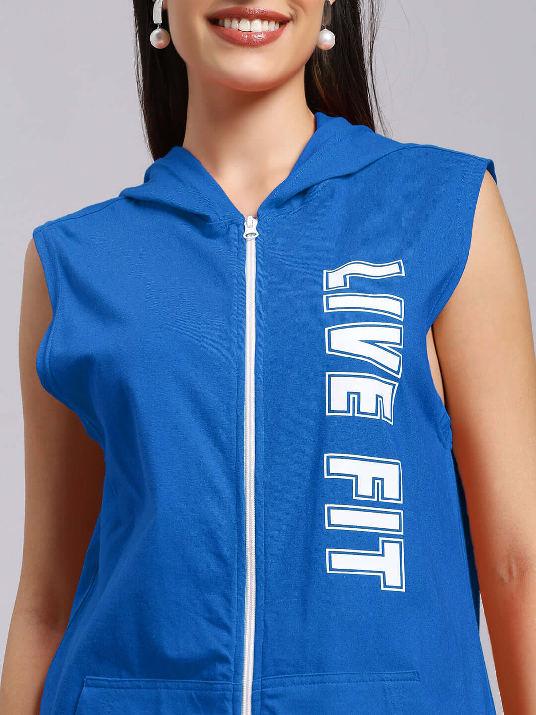 Woman wearing blue 'Live Fit' gym hooded t-shirt, sleeveless design, emphasizing sporty style and breathable comfort.