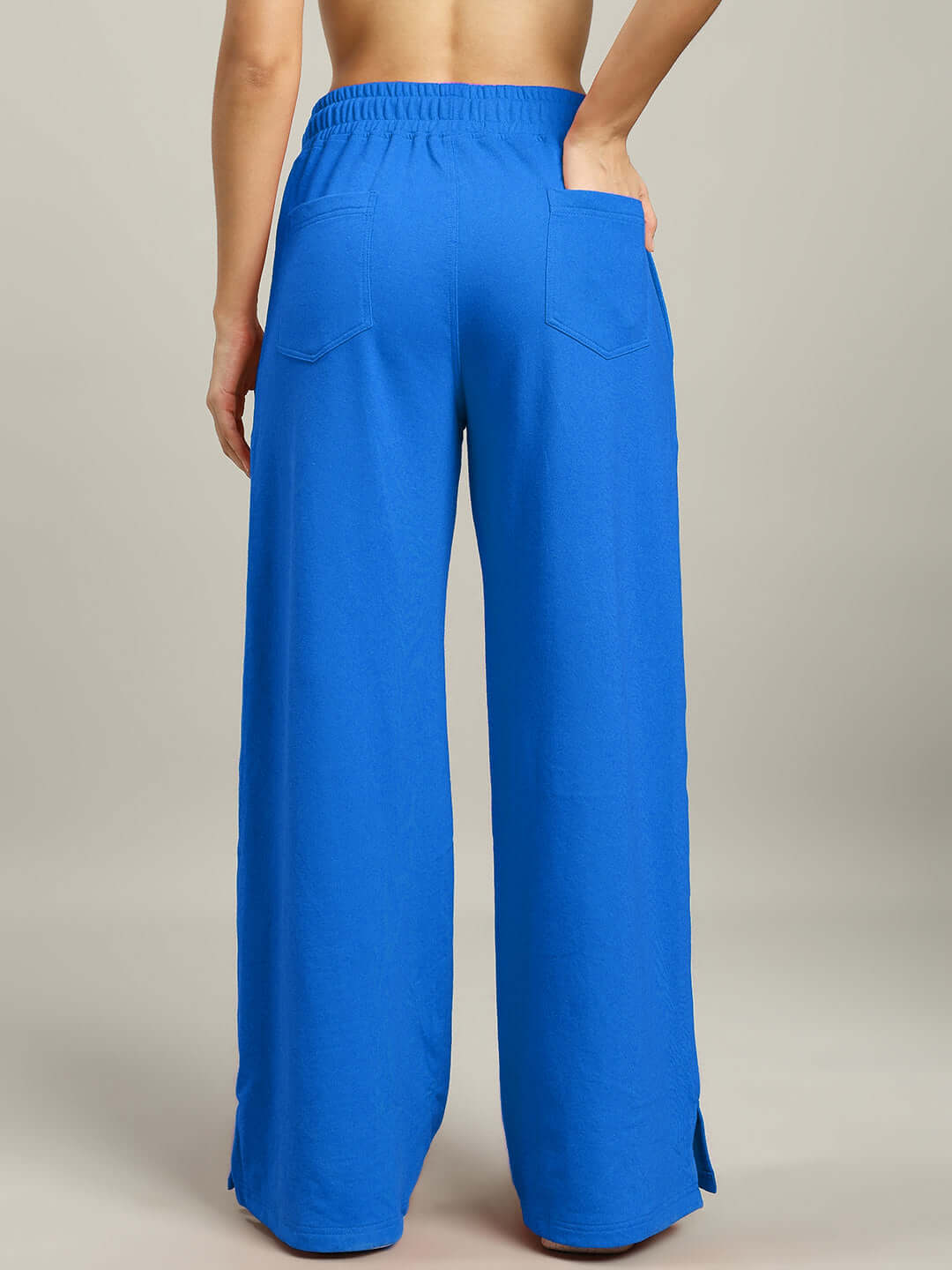 Back view of Women's United Stripe Joggers in blue, highlighting wide-leg design, elastic waistband, and back pockets.
