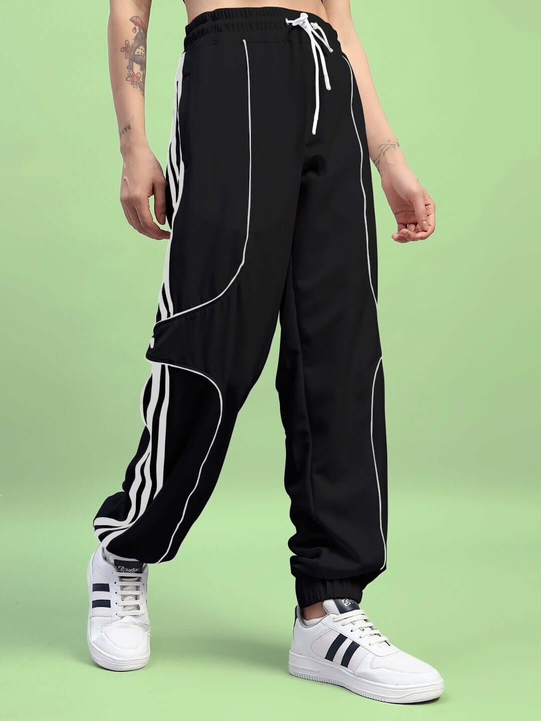 Black women's Bolson stripes relaxed-fit joggers with custom fit option, shown with white sneakers, ideal for casual and sporty wear.