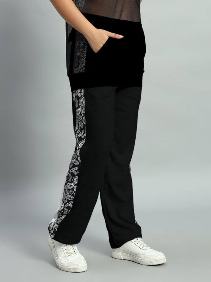 Model wearing black Boogie relaxed fit joggers with paisley stripe detail, paired with white sneakers, showcasing casual fashion style.