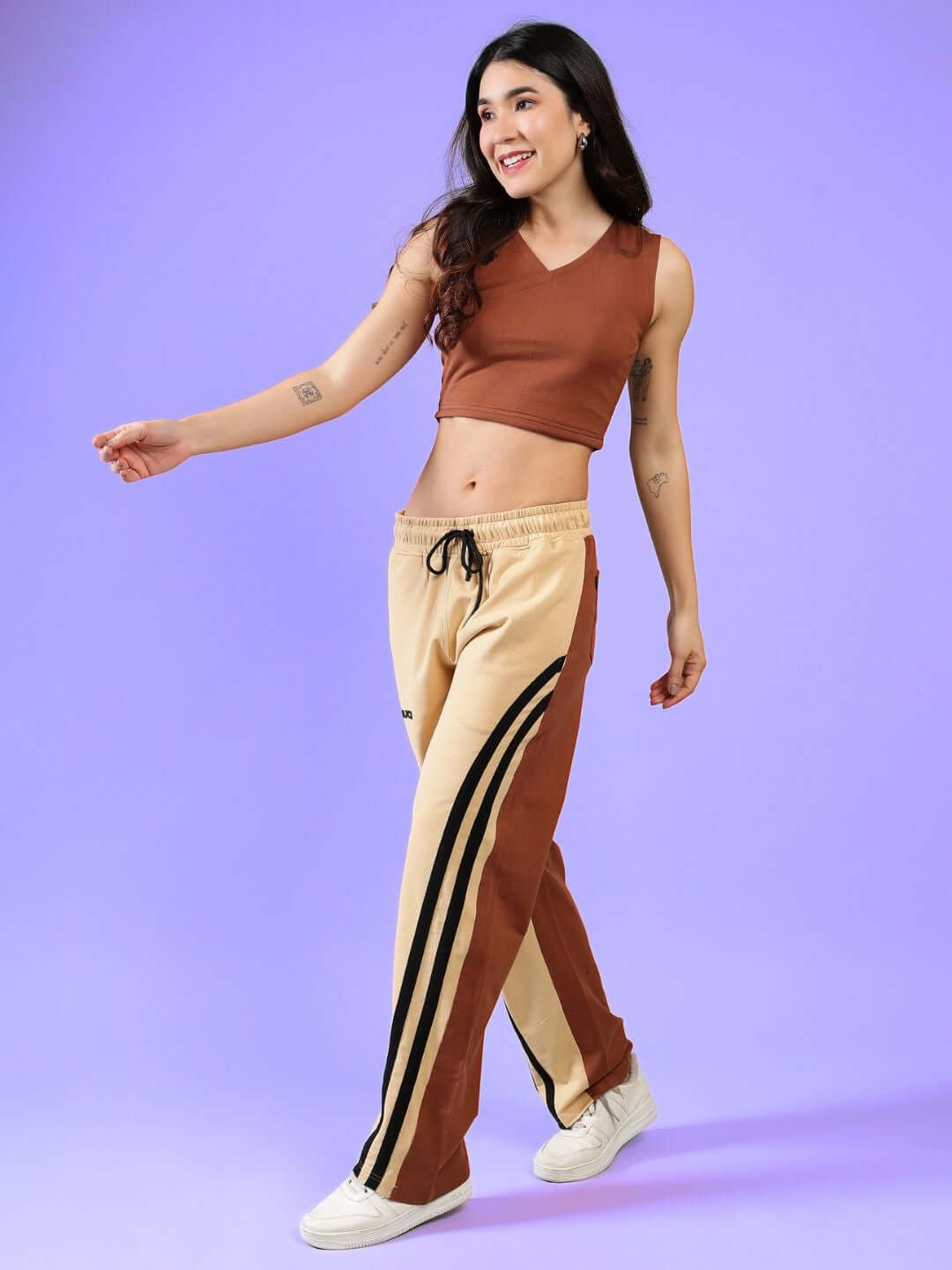Woman wearing a cream brown co-ord set, featuring a sleeveless top and track pants. Ideal for casual wear, made from premium cotton.