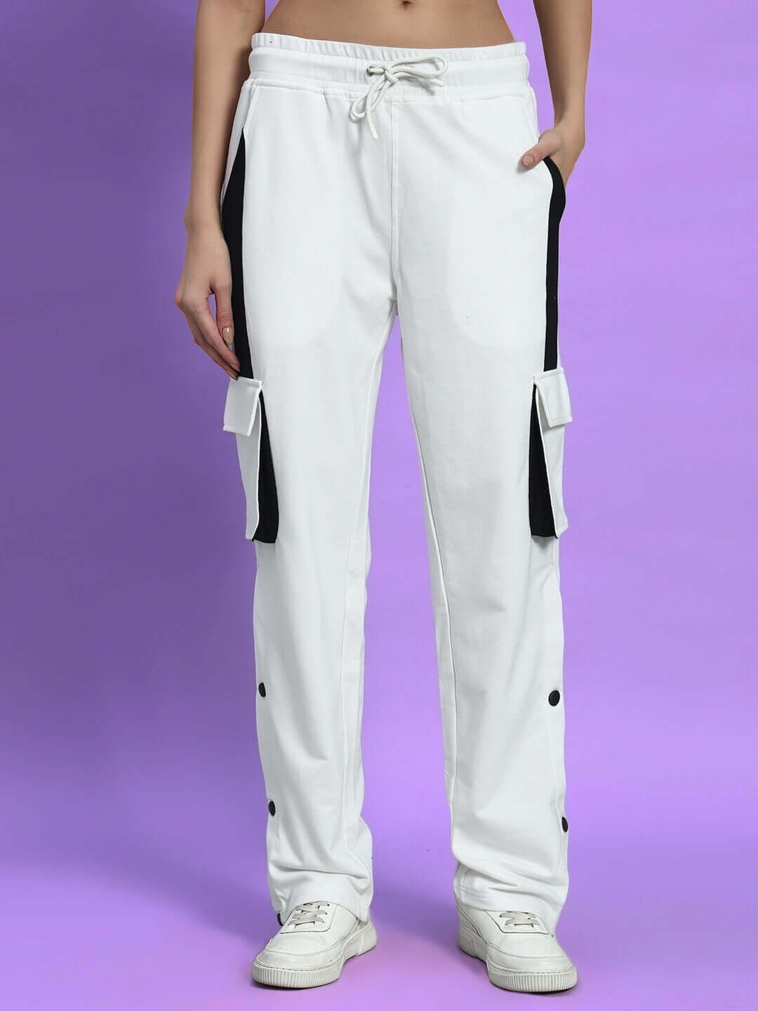 WOMEN'S BRACKET CARGO PANT WHITE BLACK HIGHLIGHTER with neon accents and multiple cargo pockets showcased on purple backdrop.