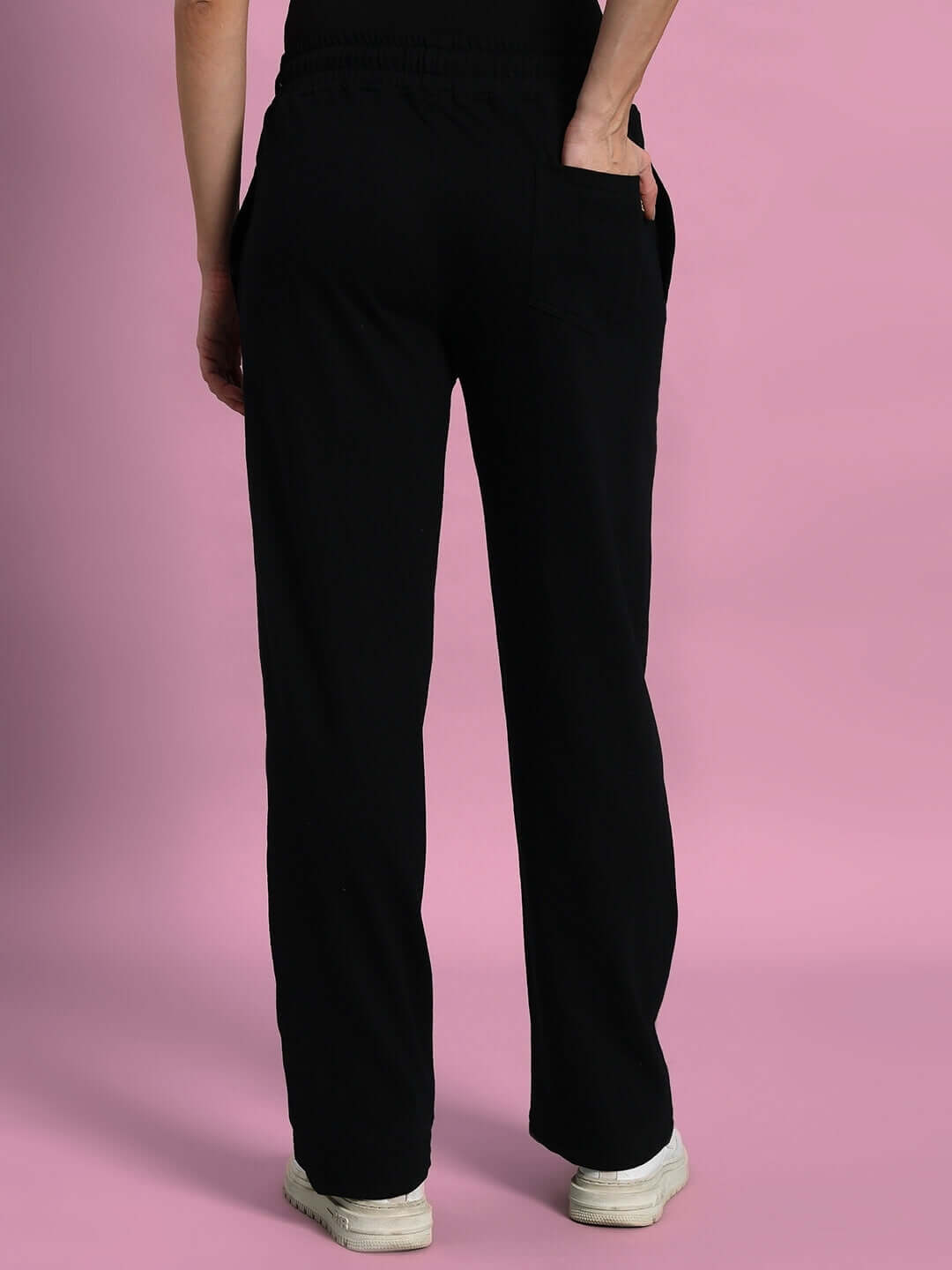 Back view of Women's Brazo Front Open Zipper Joggers in black, showcasing comfort fit design against a pink background.