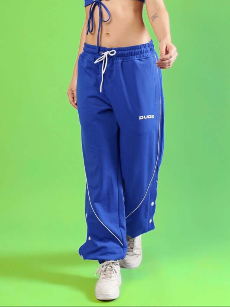 Model wearing royal blue women's BROSSFINE contrast joggers by DUDS, showcasing comfort and style, available for custom fit preorders.