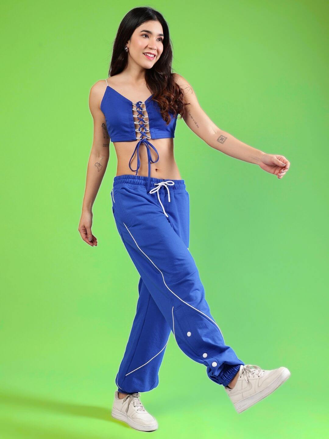 Model wearing WOMEN'S BROSSFINE CO-ORD SET in royal blue, crafted from premium cotton, showcasing comfort and style against a green background.