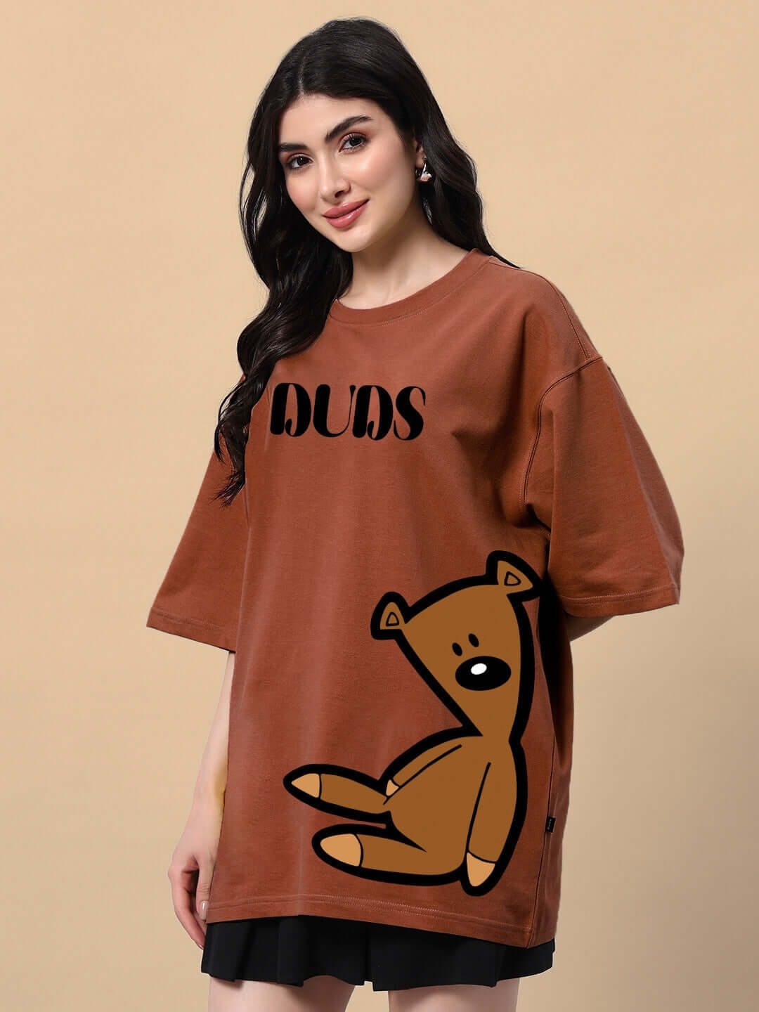 Woman wearing a brown teddy bear T-shirt, made from premium cotton blend fabric, showcasing stylish and comfortable design.