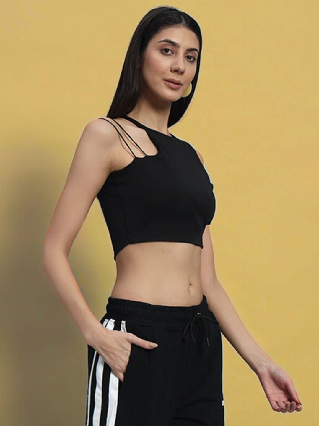 Woman wearing black women's Bussin crop-top made from premium 100% cotton, styled with casual pants on a neutral background.