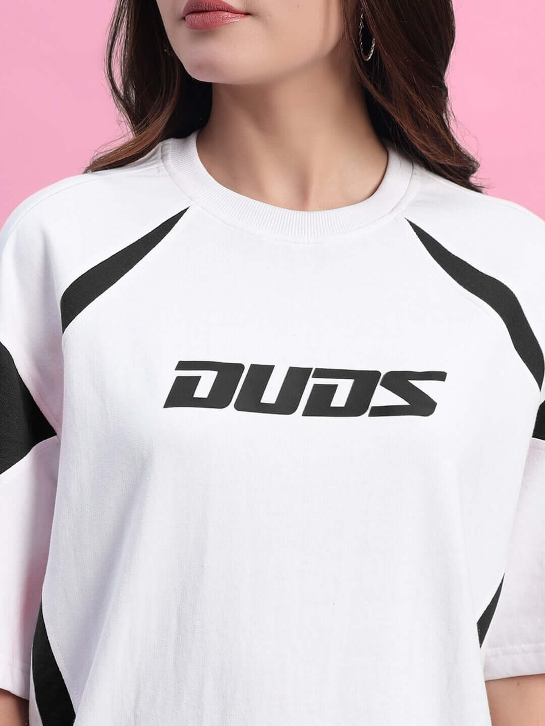 Close-up of women's white and black oversized t-shirt with bold text design, made of premium cotton elastane fabric.
