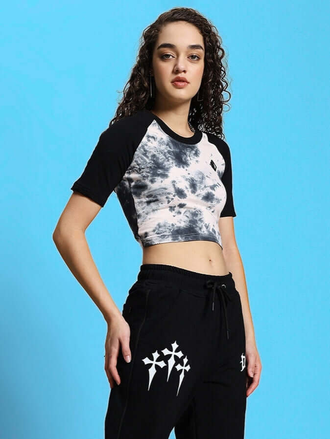 Woman wearing black-beige crop-top made from premium cotton fabric, styled with black printed pants; showcasing comfortable and trendy fashion.