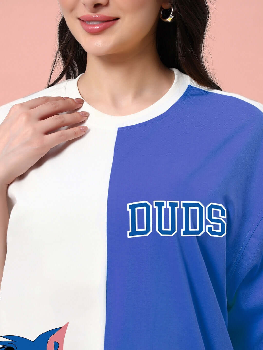 Close-up of a woman wearing a blue and off-white Duds oversized t-shirt, perfect for casual summer fashion.