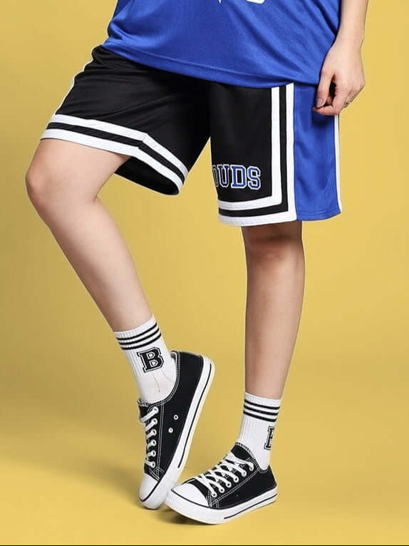 Women's regular fit shorts in blue, black, and white by DUDS, displayed with sneakers and socks for a sporty look.