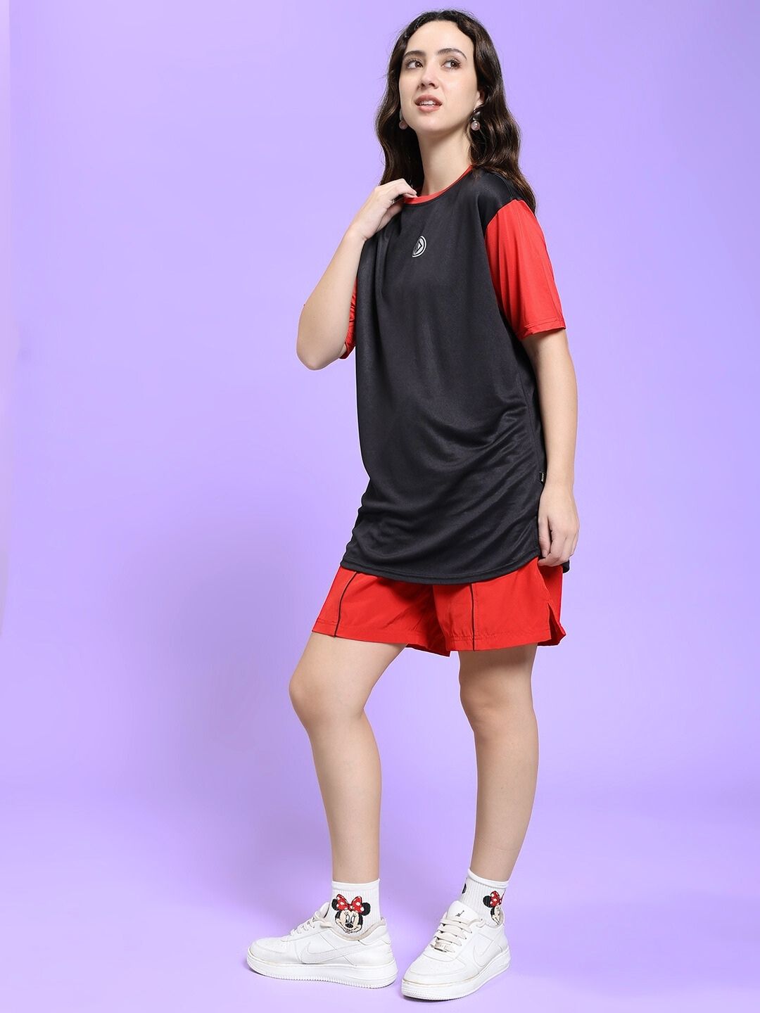 Woman wearing WOMEN CHAMPION ZONE REGULAR FIT CO-ORD SET BLACK RED against a purple background.