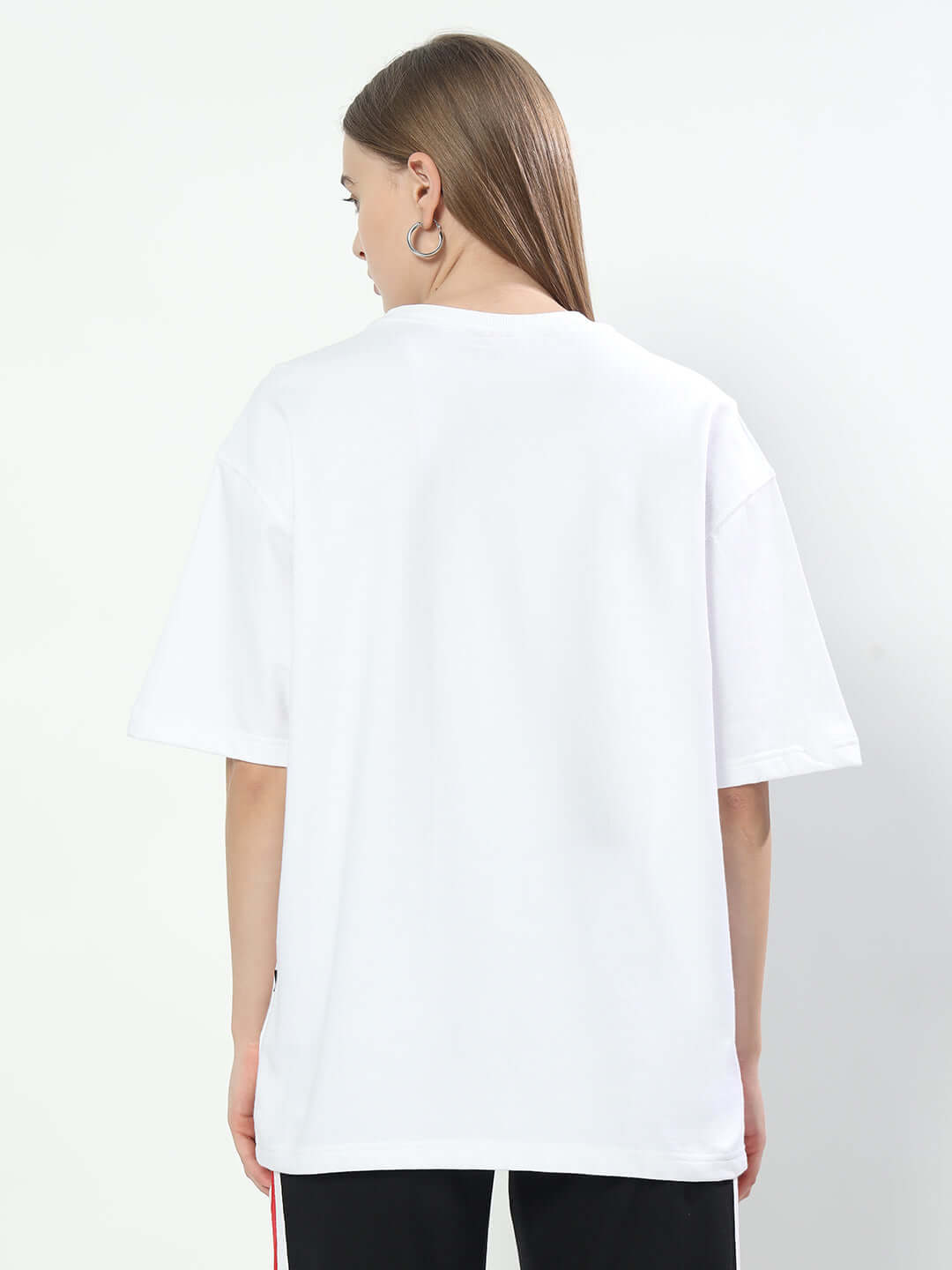 Back view of Women's Classified Reflector Over-sized T-Shirt in white, made from premium cotton blend, showing loose fit and style.