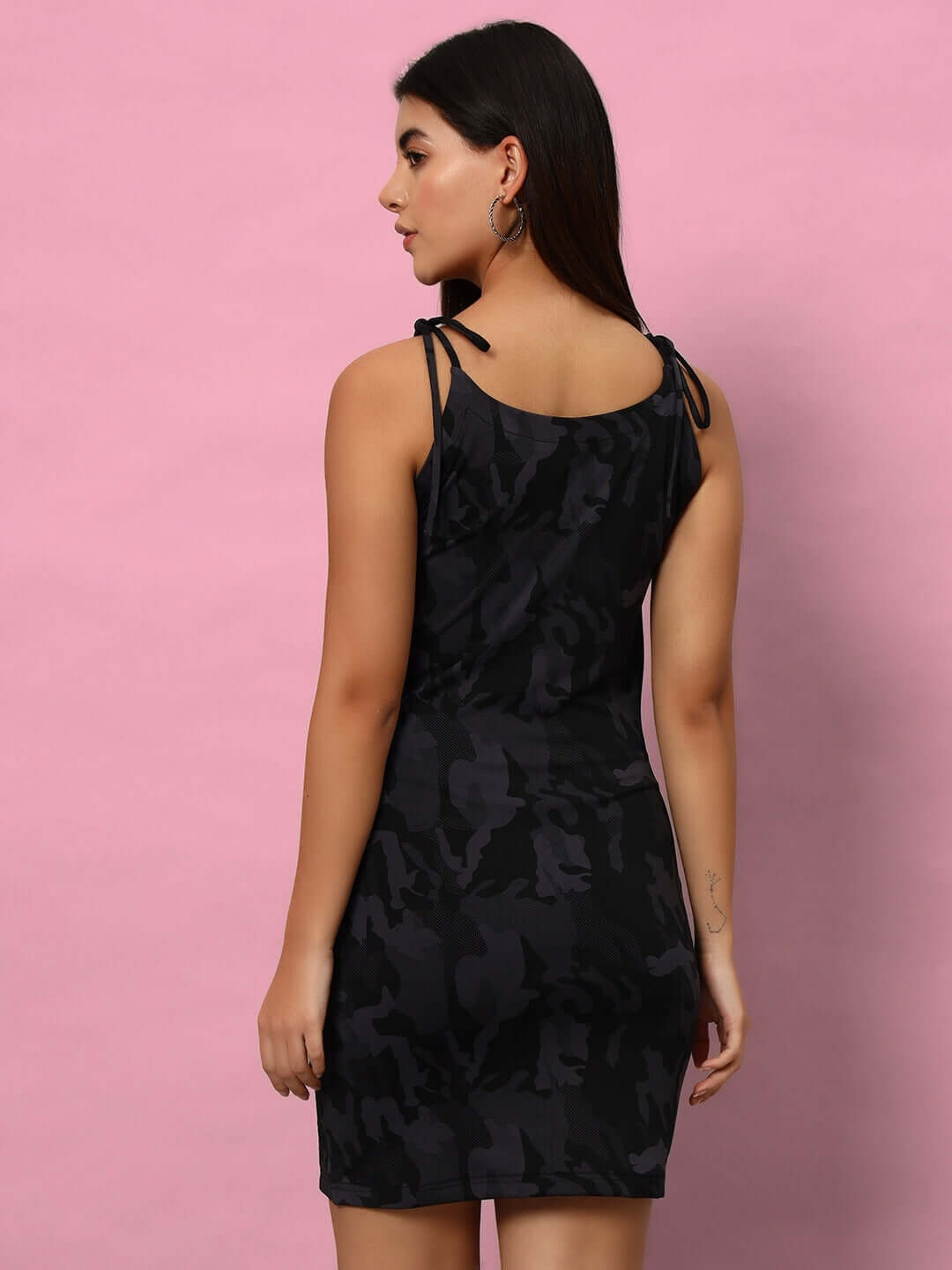 Woman modeling a Women's Cocktail Dress with Mesh in Camo Blue, polyester-spandex blend, four-way Lycra, back view against pink background