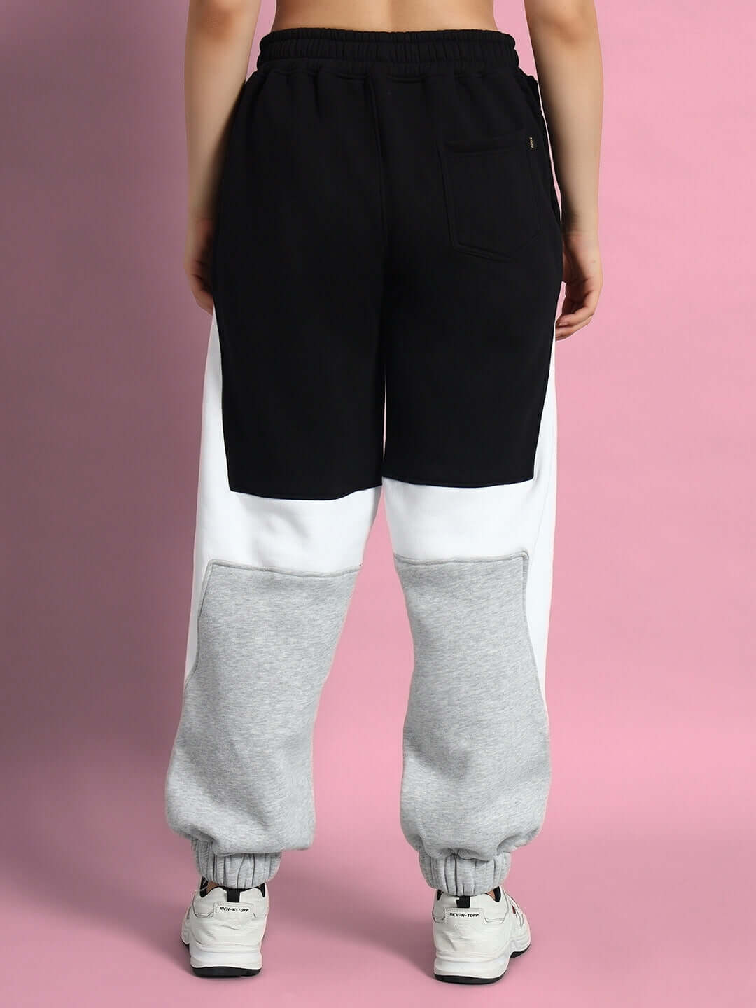 Back view of black, white, and gray WOMEN WD SWORD FLEECE COLORBLOCK CARGO PANT, showcasing colorblock design and comfort.
