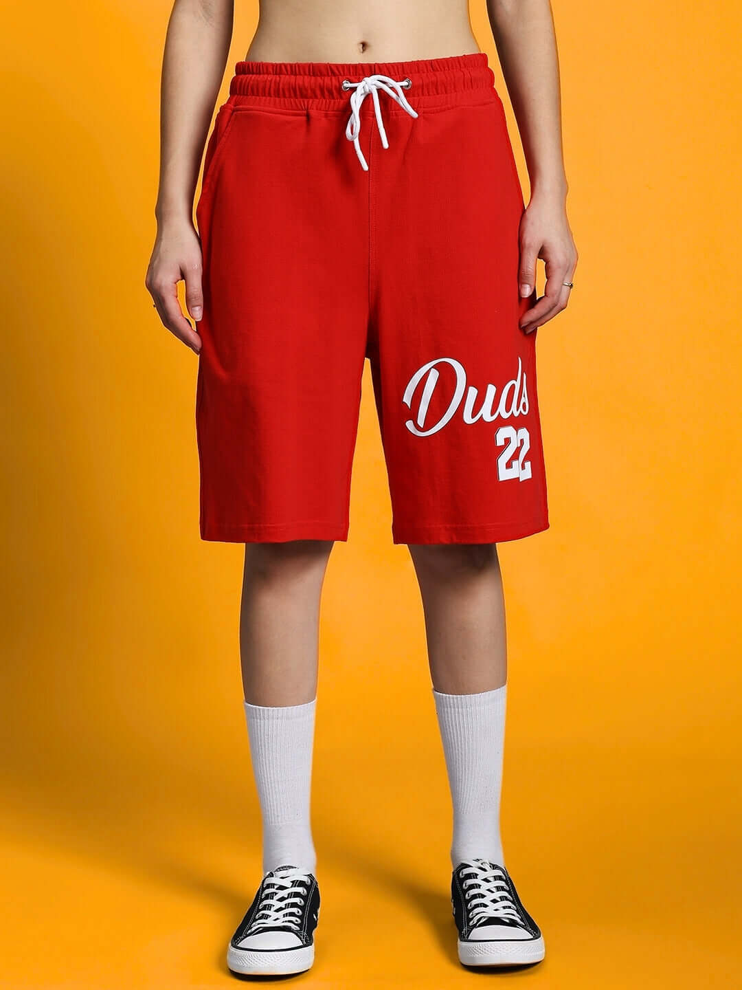 Woman wearing WOMEN'S COLUMBIA 22 PRINT SUMMER CO-ORD SET BLACK RED with sporty red shorts and sneakers.