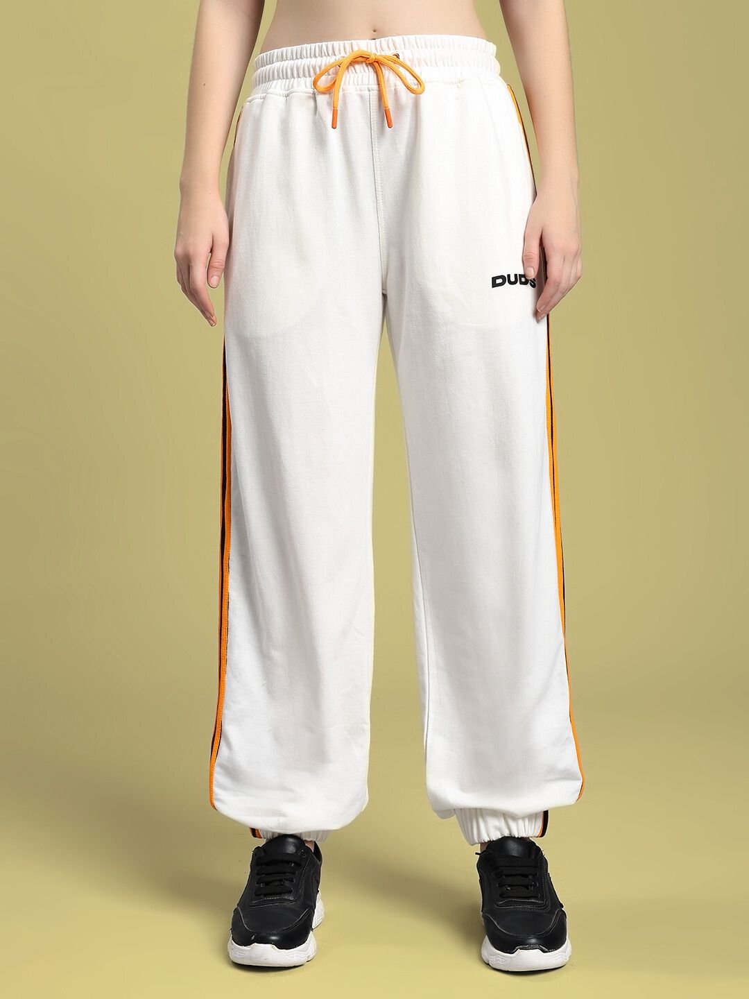 WOMEN'S COMFORT FLEX STRIPE JOGGER OFF-WHITE with orange side stripes, showcasing relaxed style and comfort.