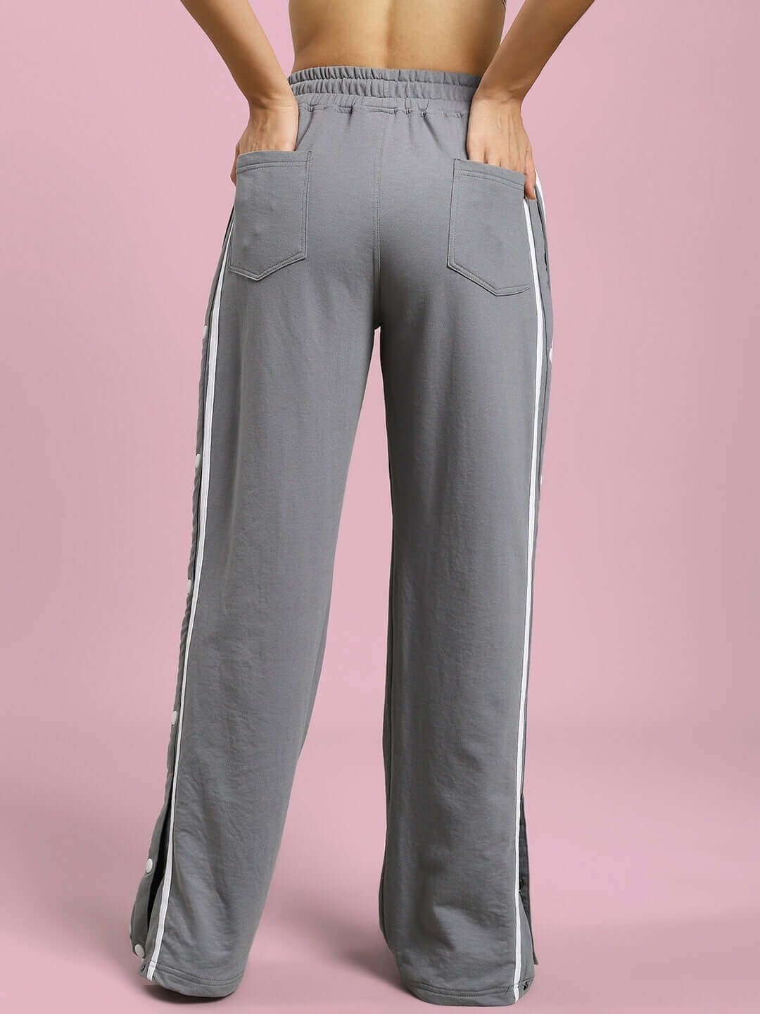 Back view of women's grey contrast panel joggers by DUDS, featuring stylish white side stripes and a comfortable fit.