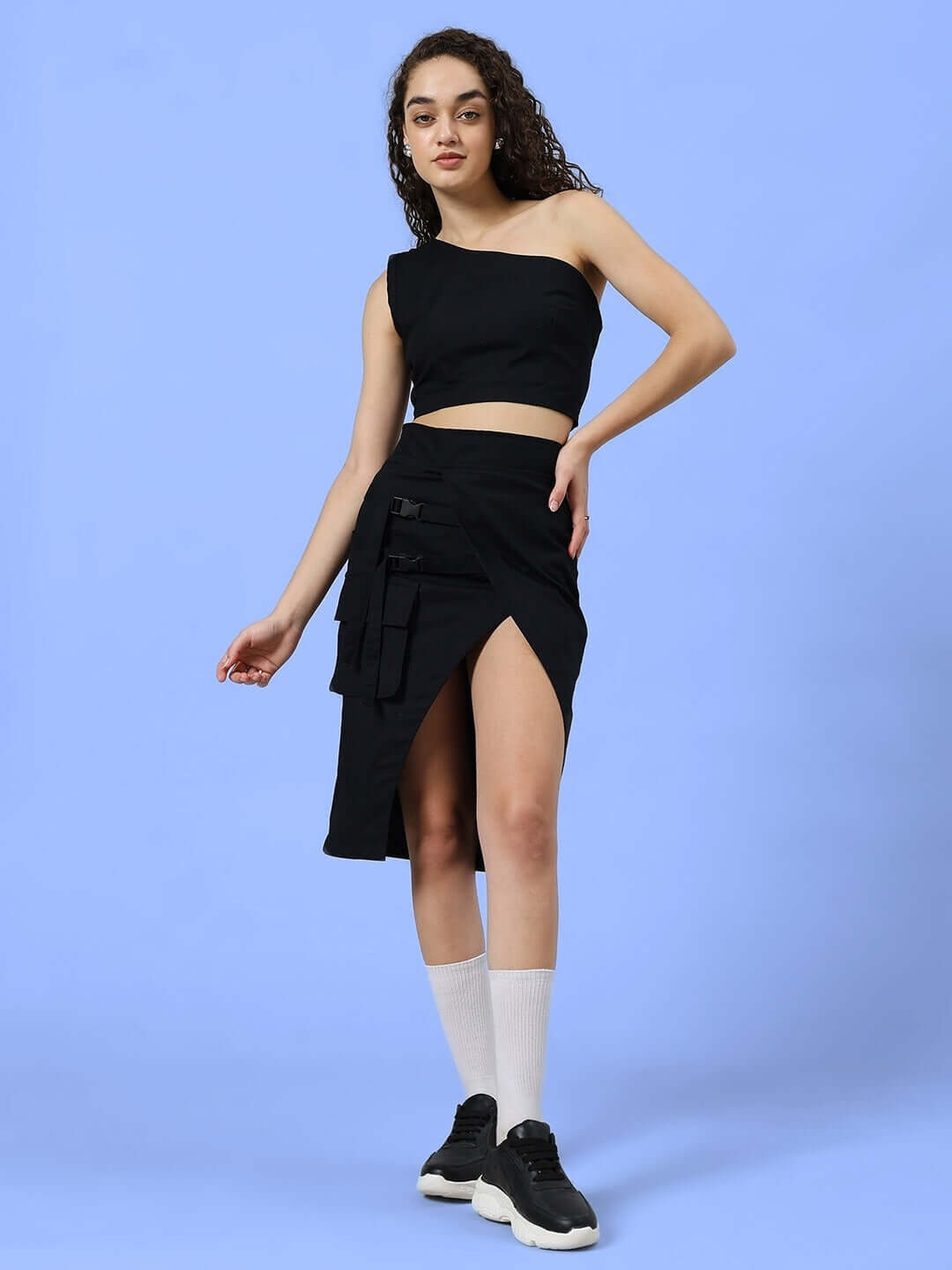 Model wearing black Women's Cooksey Designer Skirt with custom fit option, showcasing stylish design on blue background.