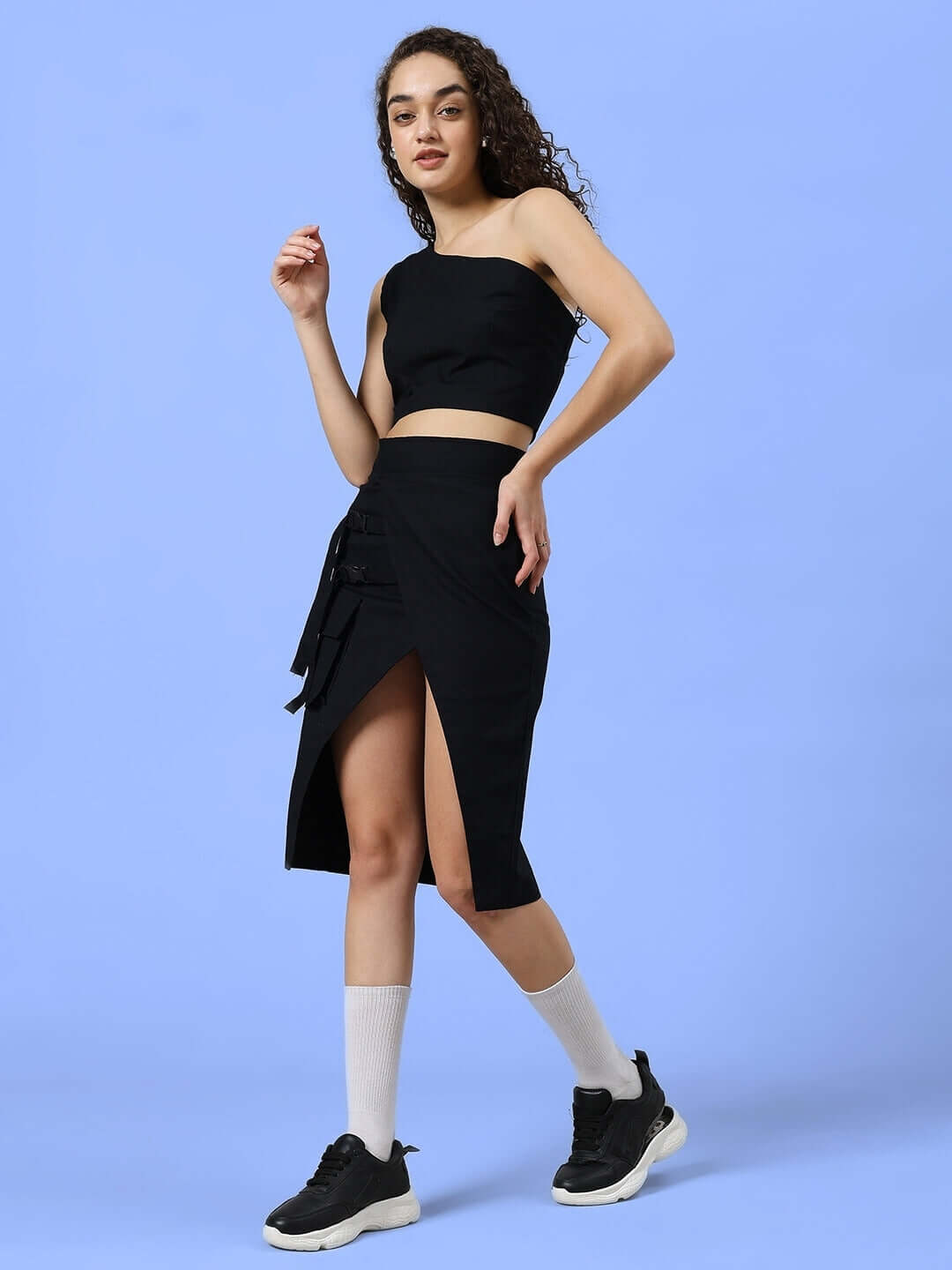 Model wearing WOMEN'S COOKSEY FIT & FINE CO-ORD SET BLACK, featuring a sleeveless top and slit skirt, crafted from premium cotton twill fabric.