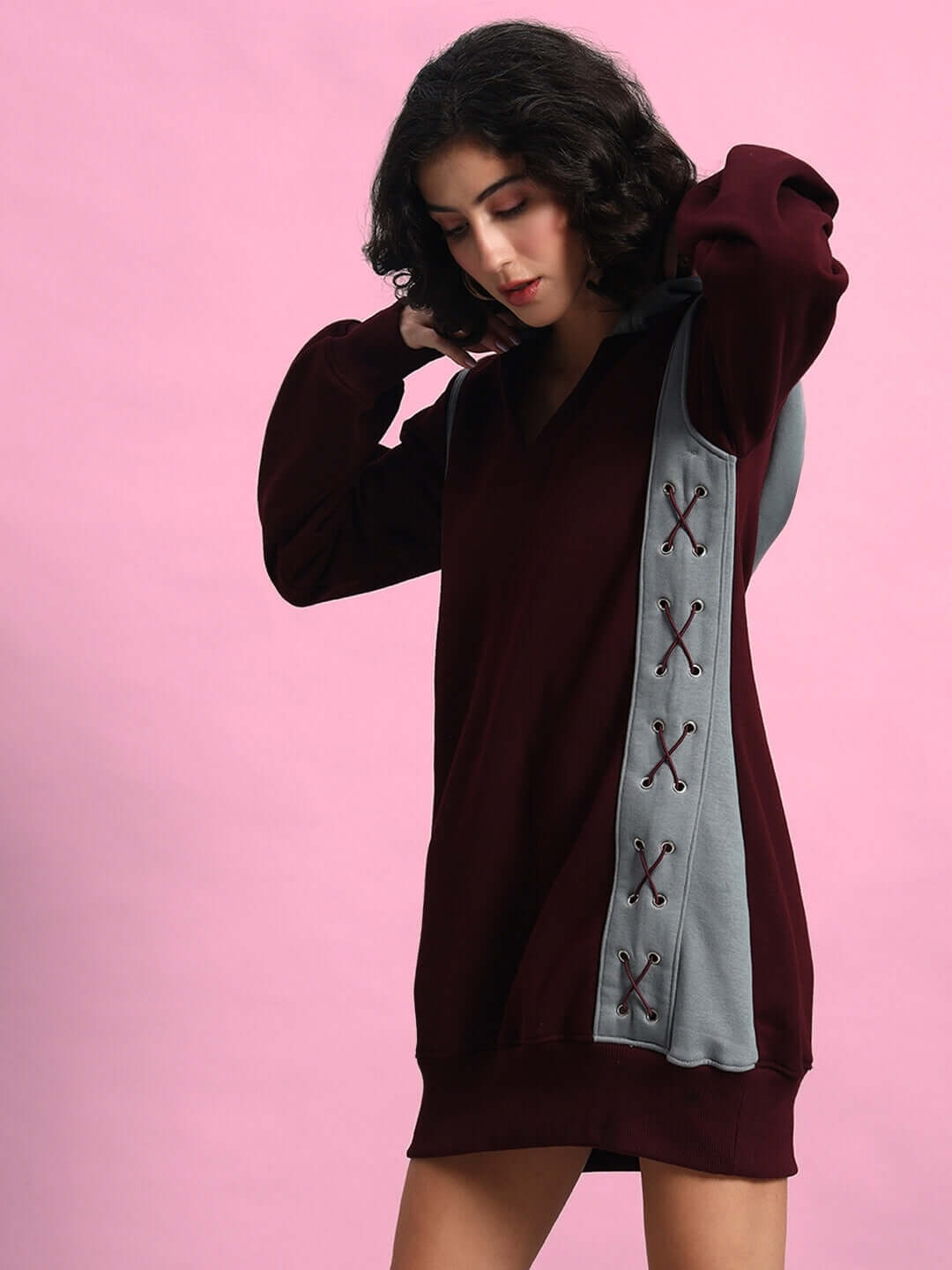WOMEN CRISS CROSS FLEECE HOODIE WINE GREY with unique side crisscross design, modeled against a pink background, offers customizable fit options.