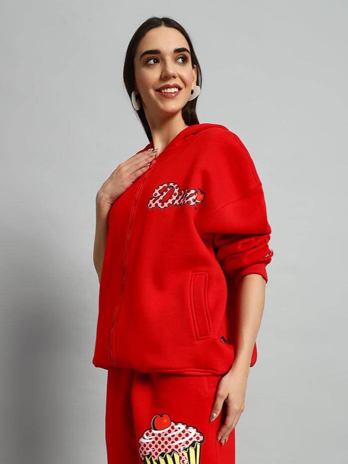 Woman wearing WOMEN CUPCAKE FLEECE HOODIE RED, showcasing the vibrant red color and modern cozy design with a cupcake print.