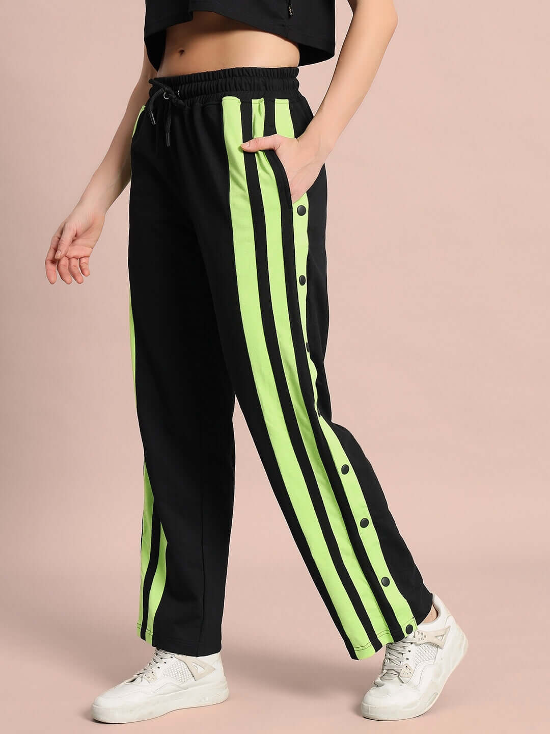 Model wearing women's dancer joggers in black with neon green stripes, featuring a comfortable fit and customizable options.