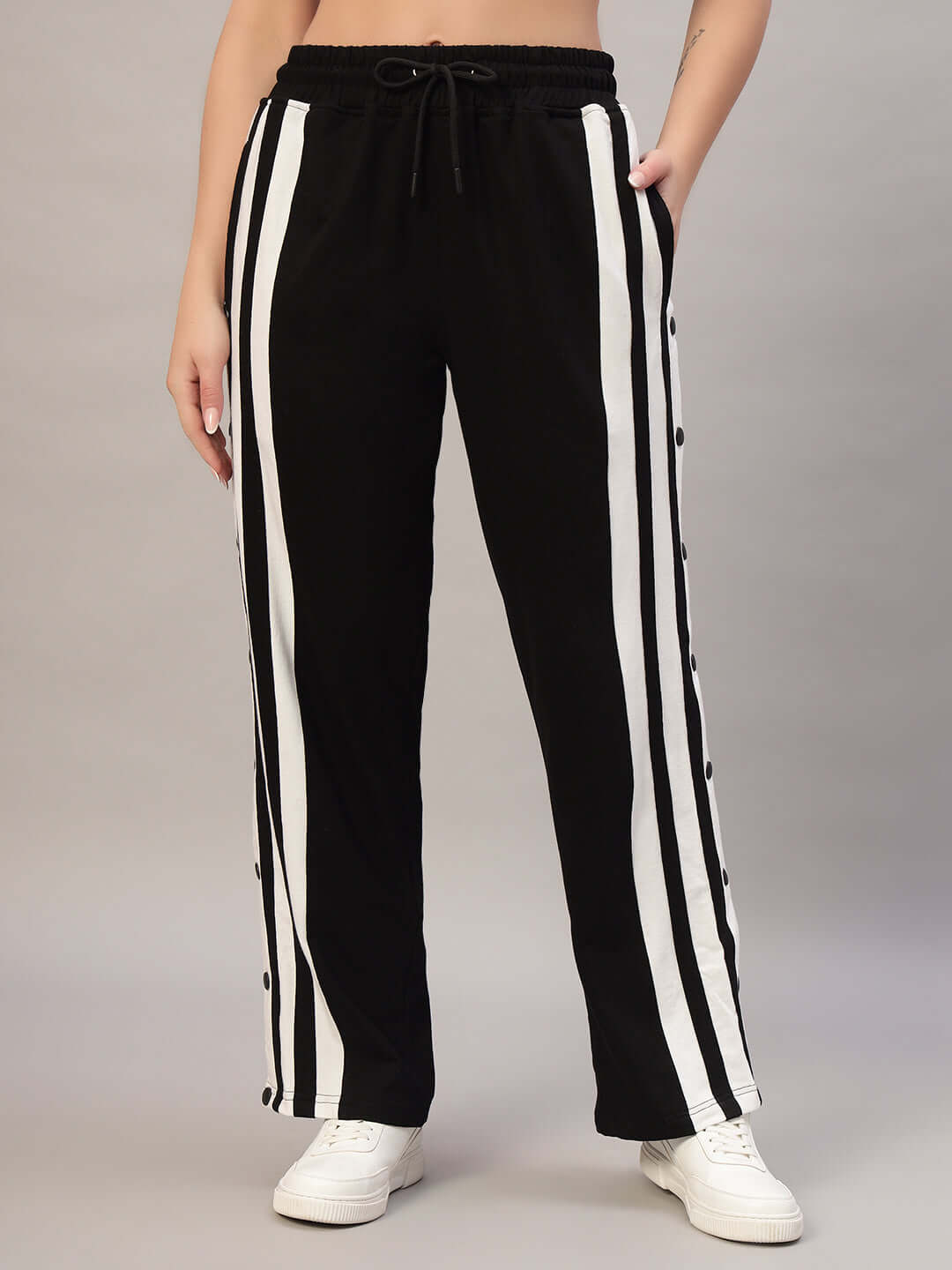 Women's black and white joggers with side stripes, showcased for "Dancer" collection by DUDS, customizable and made to order.