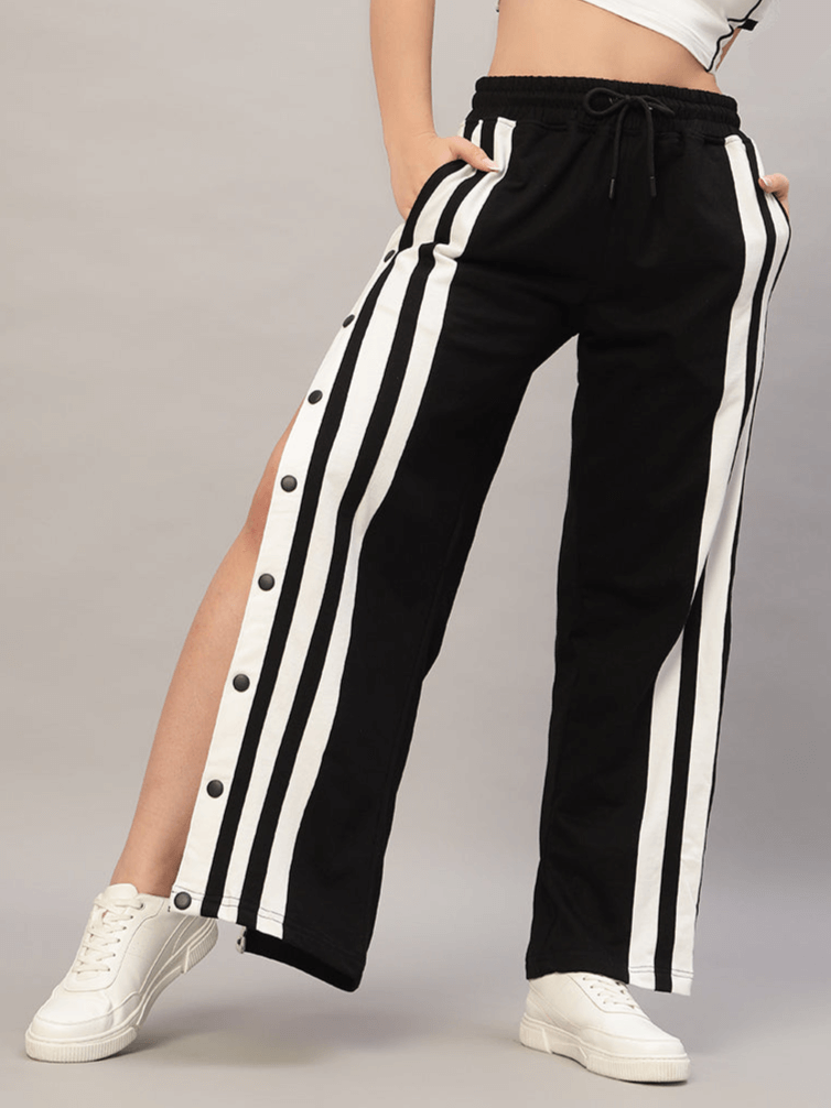 Woman wearing black and white dancer joggers with side stripes, customizable fit, by DUDS. Made to order by experienced tailors.