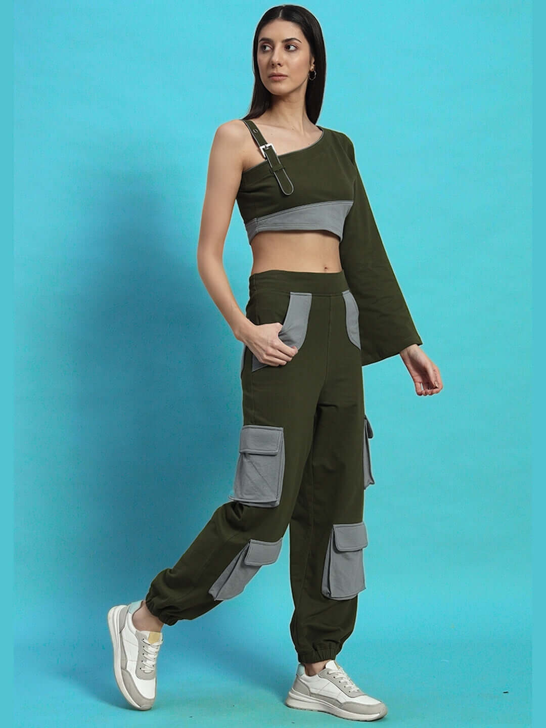 Alt Tag: Woman wearing Women's Daniel Co-Ord Set in Olive-Grey with relaxed fit joggers and asymmetric top, styled with sneakers.