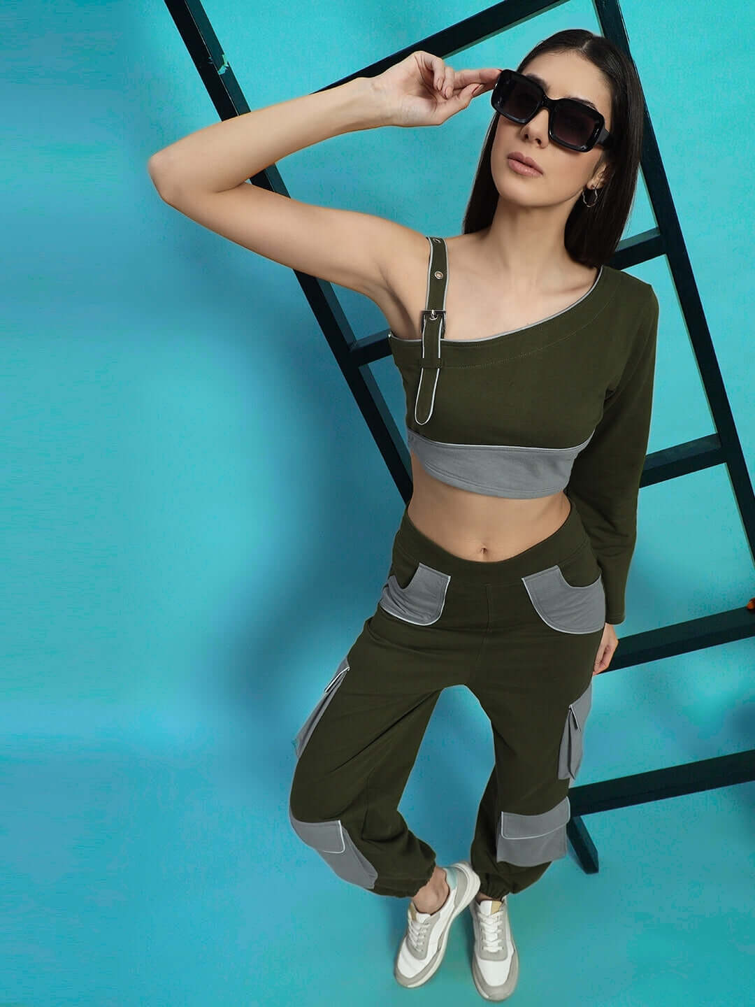Stylish woman wearing WOMEN'S DANIEL CO-ORD SET OLIVE GREY with sunglasses and ladder backdrop