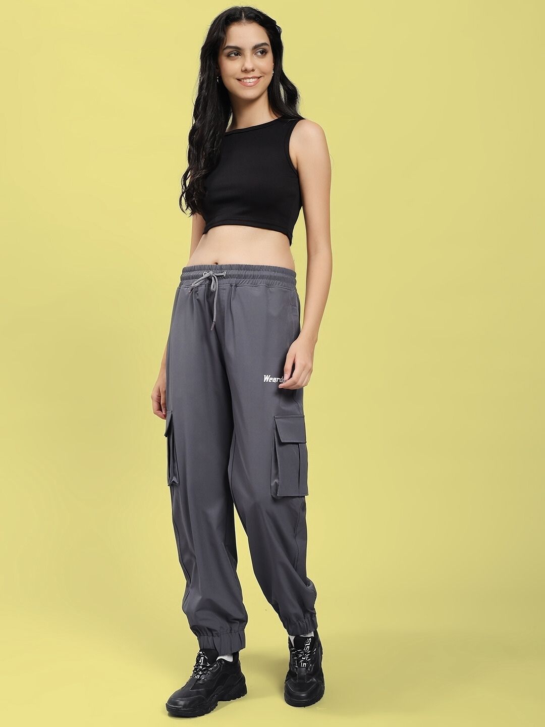 Woman wearing WOMEN'S JACK RELAXED FIT MULTI POCKET CARGO DARK GREY pants, showcasing casual utility style in dark grey trousers.